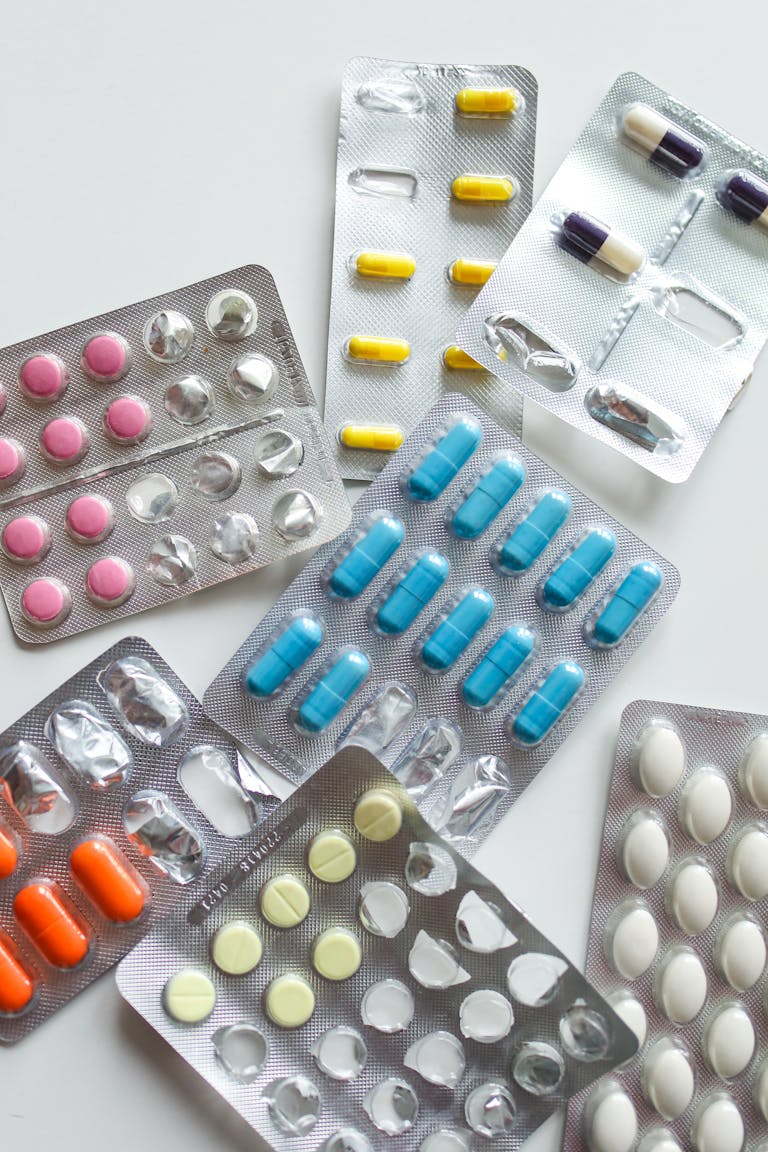 Various colorful medicine tablets in blister packs, emphasizing healthcare and pharmaceutical concepts.