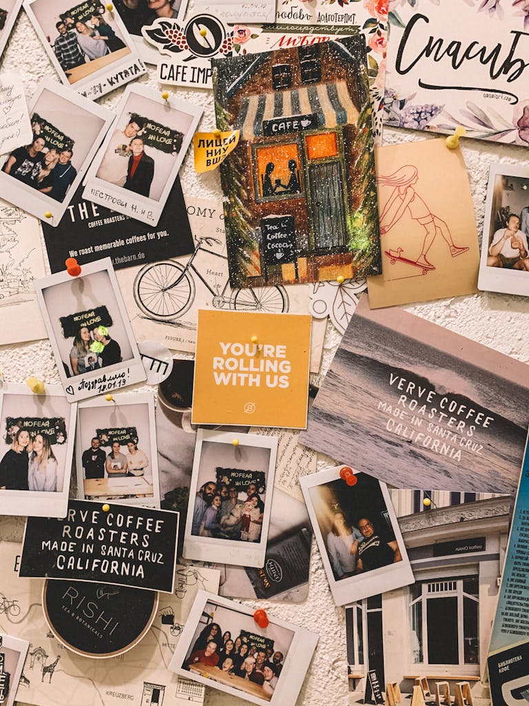 Vibrant wall filled with Polaroid pictures and artistic cutouts capturing memories and creativity.
